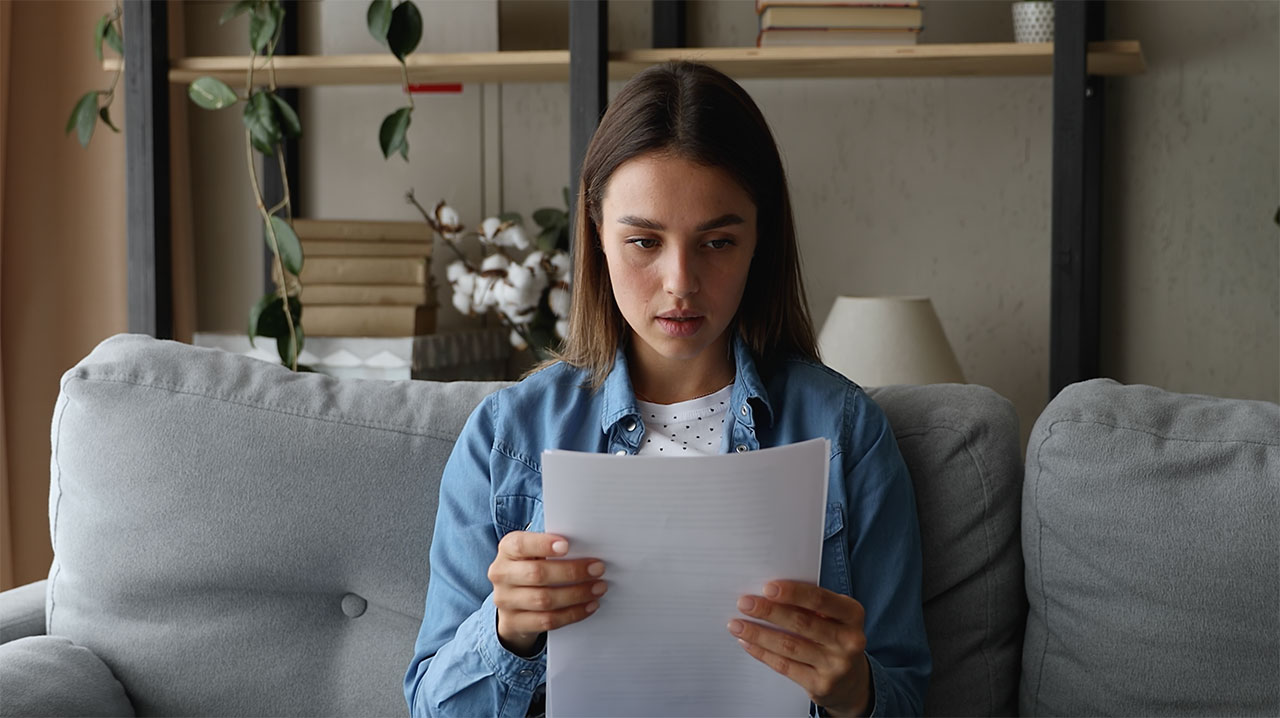 Concerned woman looking over healthcare documents
